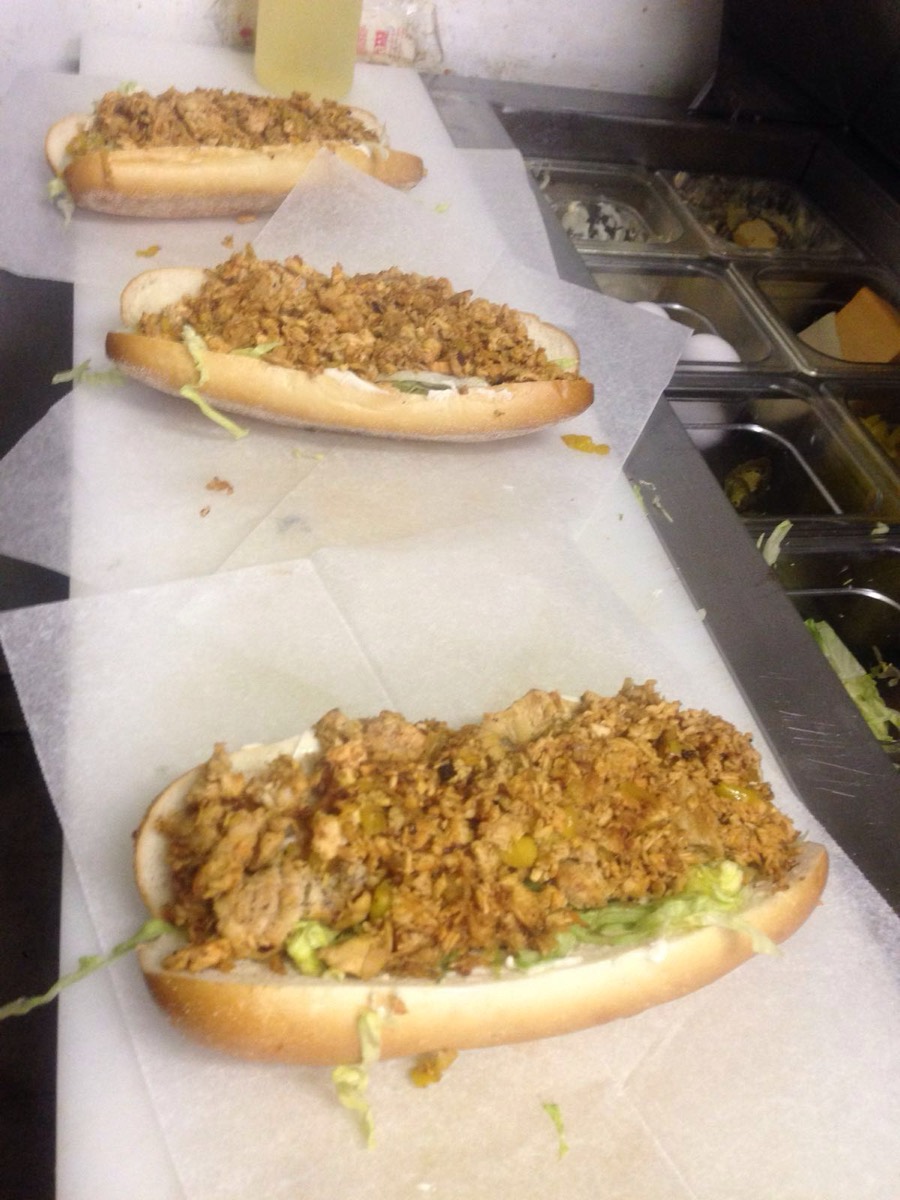 Chicken cheesesteaks with fried onions on the prep counter