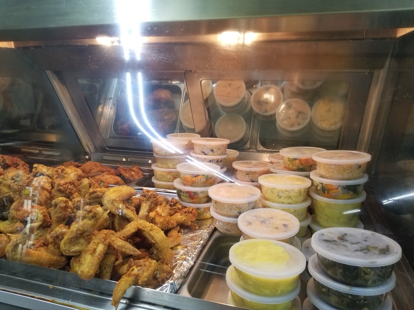Fried chicken and wings in the hot case at Ray's