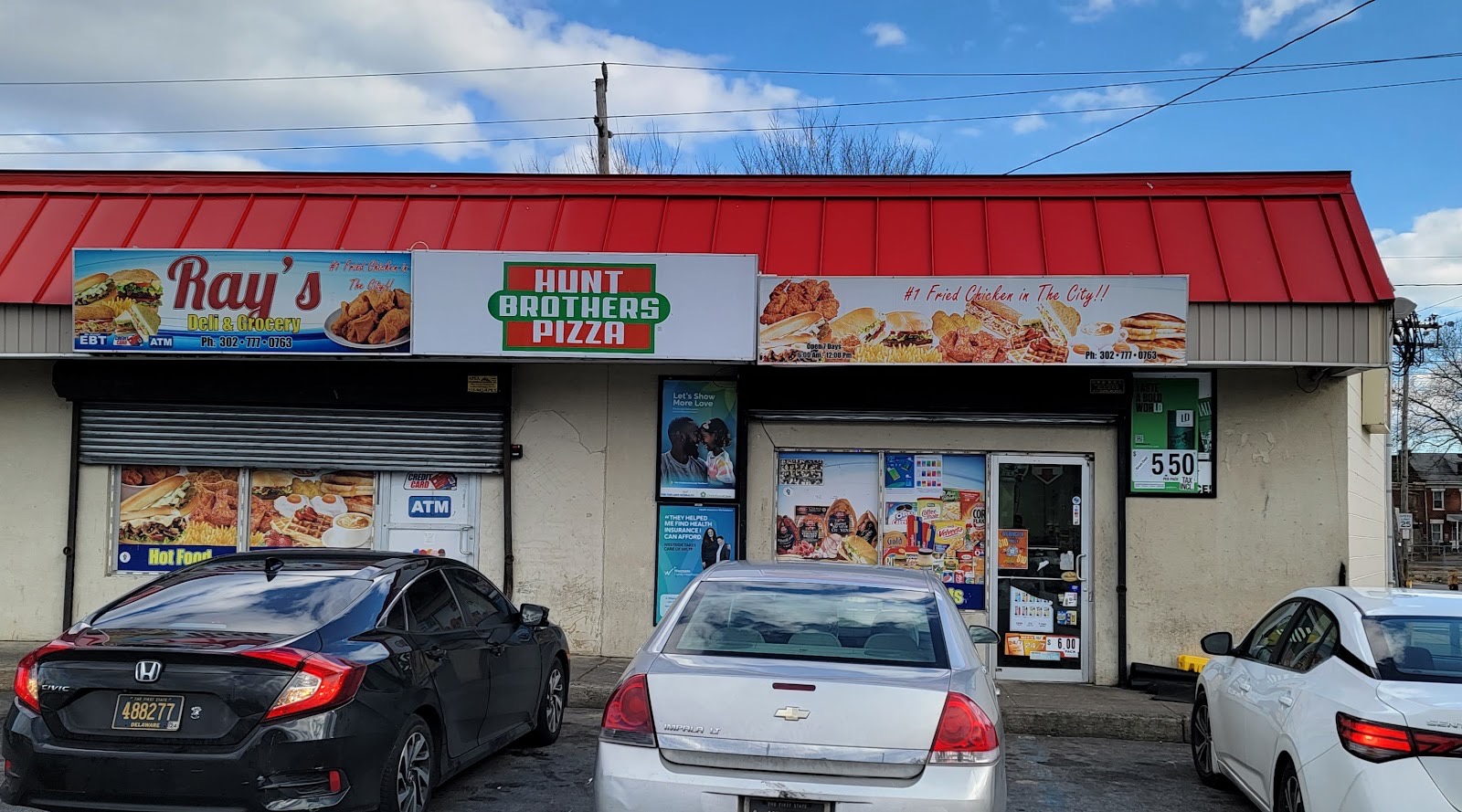Ray's Deli & Grocery storefront on Northeast Boulevard with its red awning